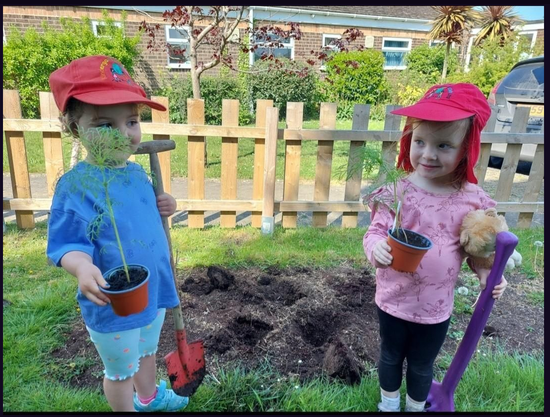 Two children from Whitstable Day Nursery and Kids planting vegetables in the garden using spades
